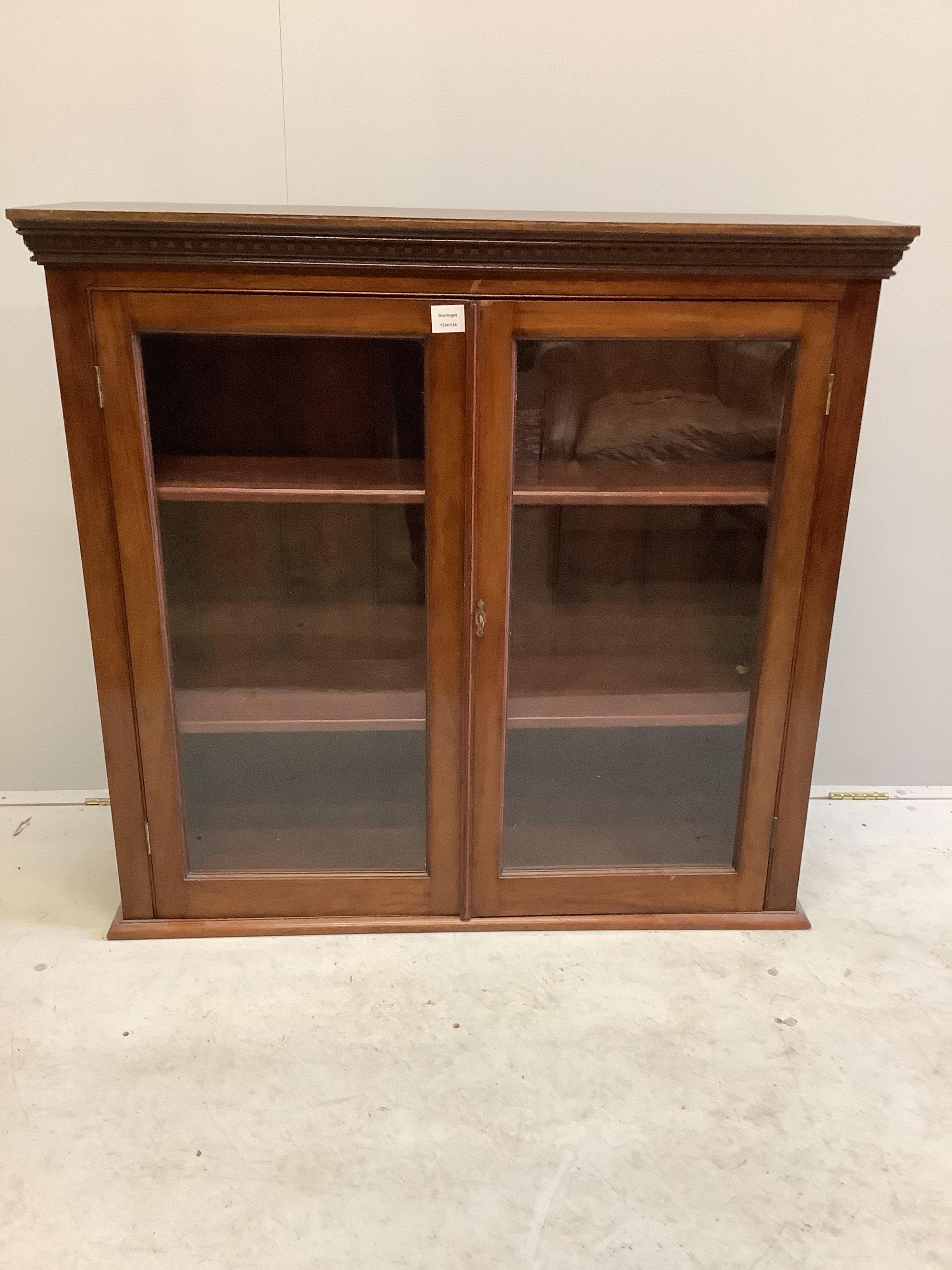 An early 20th century glazed mahogany bookcase, width 107cm, depth 28cm, height 102cm